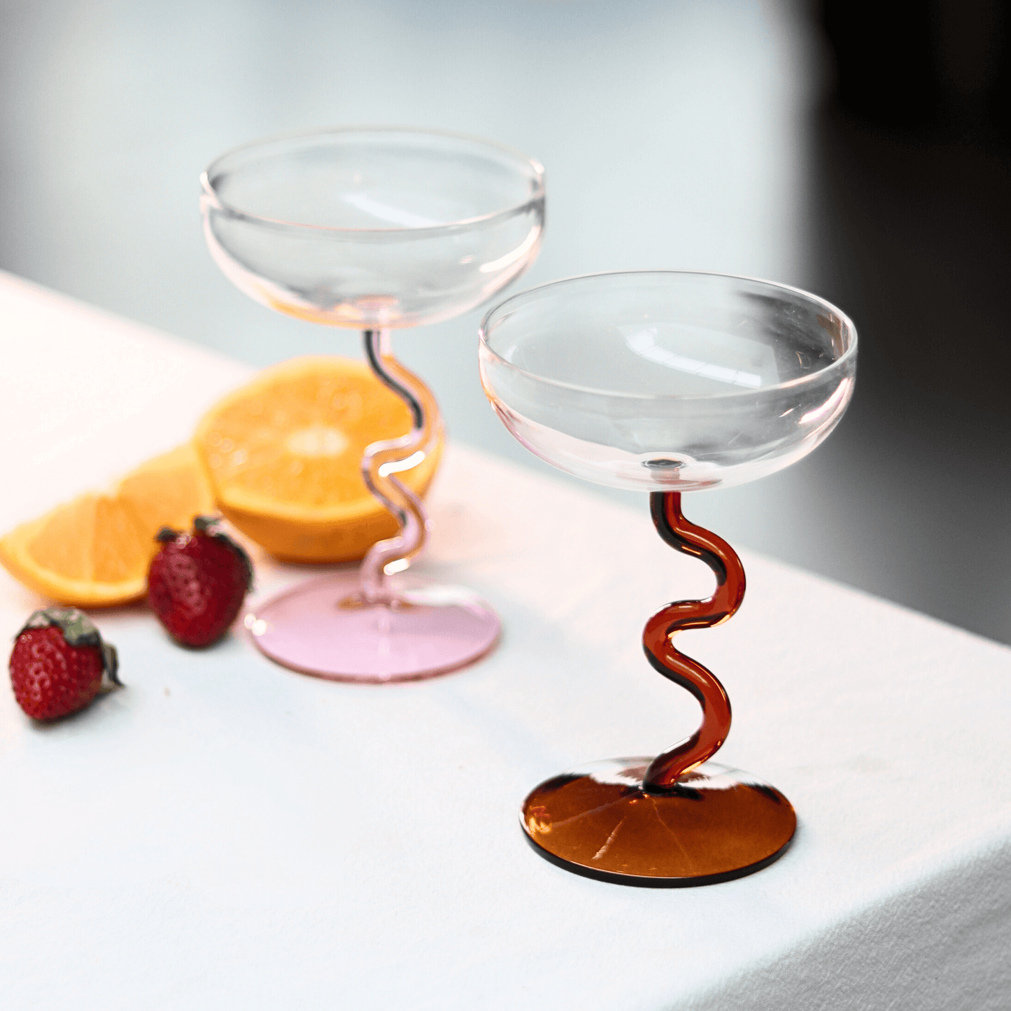 Amber Swirl Cocktail Glass Set with vibrant swirling bases, artisan craftsmanship elevating your barware decor.