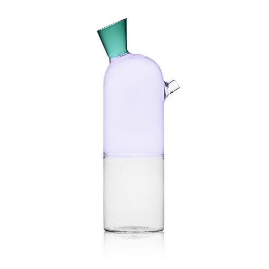 Clear glass bottle with a green cap on a white background, labeled 'Trending'.