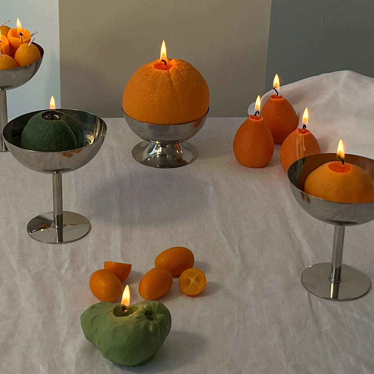 Artisan Cherimoya Candle display with unique handcrafted decor in vibrant colors on a white table.
