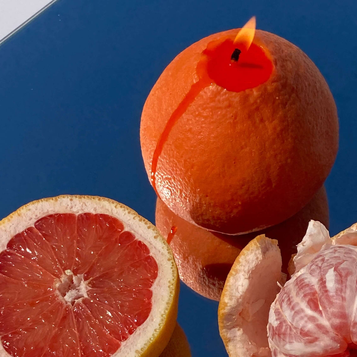 Large hand-poured soy wax grapefruit candle shaped like a real grapefruit, the hero of Marilu's quirky scented candle guide