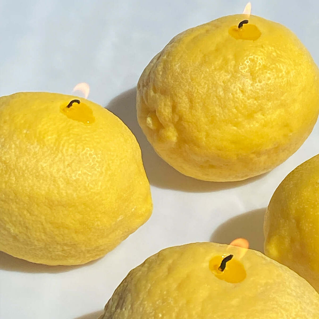 Large Lemon Candle - artisan handcrafted decor featuring citrus-scented lemons in a playful arrangement.
