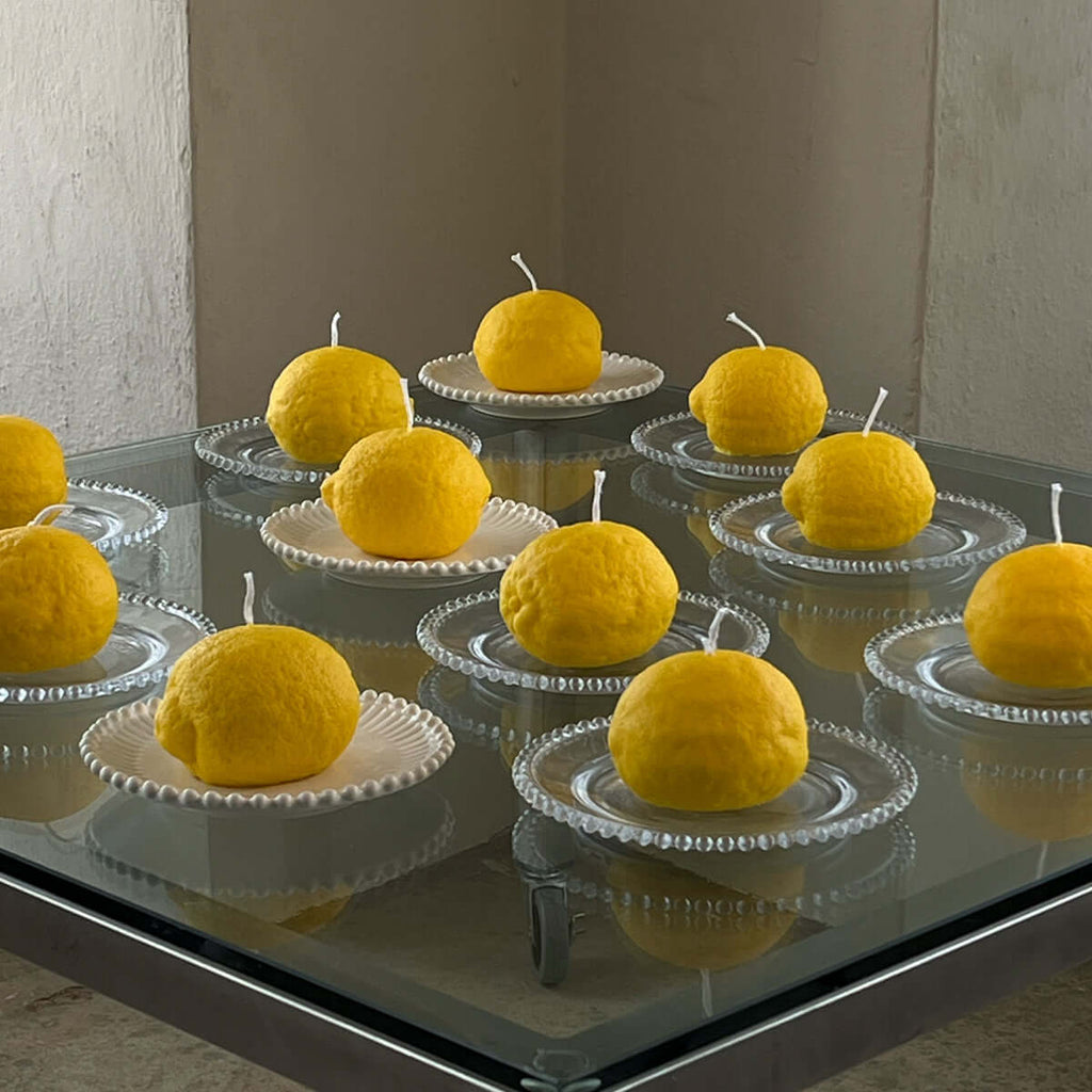 Large Lemon Candle displayed on elegant plates, showcasing artisan handcrafted decor to brighten any space.