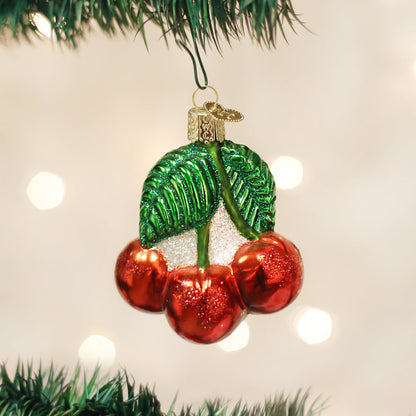 Cherries Ornament, a handcrafted artisan decor piece, artfully designed with shiny red cherries and vibrant green leaves.