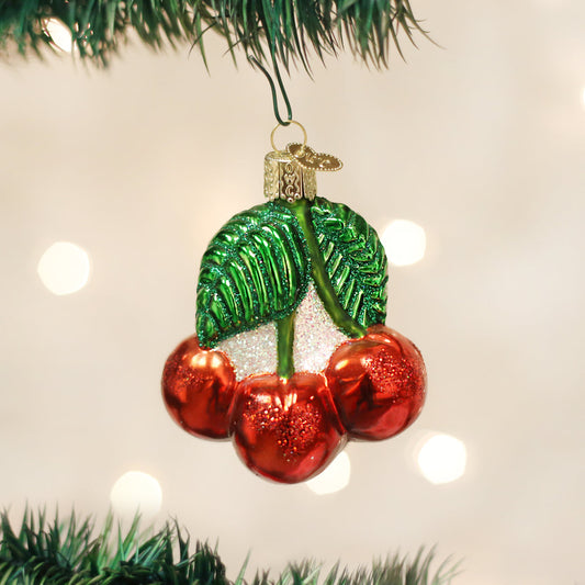 Cherries Ornament, a handcrafted artisan decor piece, artfully designed with shiny red cherries and vibrant green leaves.