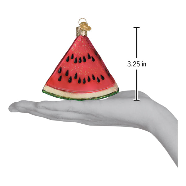 Hand holding a Watermelon Wedge Ornament, a handcrafted artisan decor piece measuring 3.25 inches.