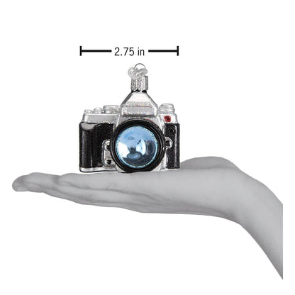 Camera Ornament displayed in hand, artisan handcrafted decor for photography lovers.