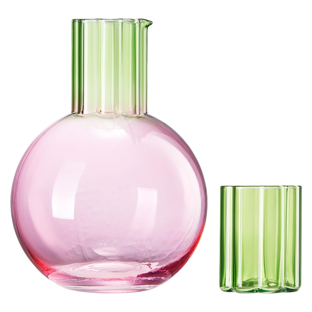 Pink glass carafe and green glass tumbler on a white background