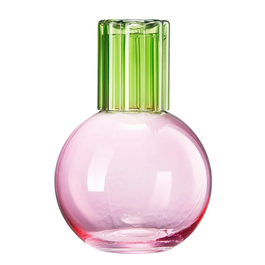 Pink glass bottle with a green cap on a white background