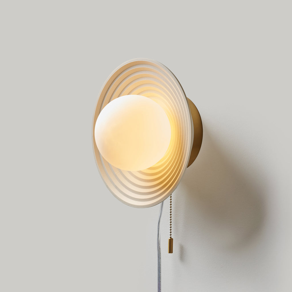 Echo Sconce with concentric circle design, artisan handcrafted wall decor for stylish lighting solutions.