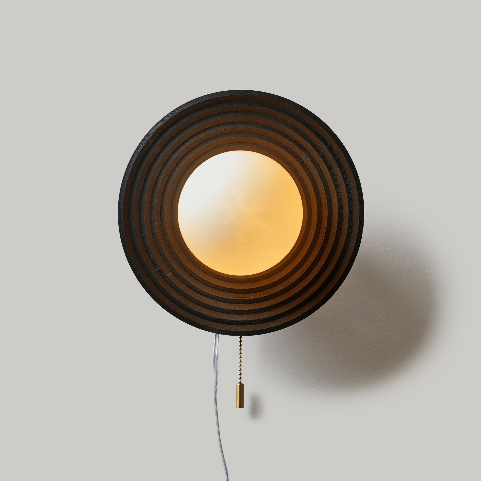 Handcrafted Echo Sconce with concentric circle design, ideal artisan decor for stylish wall lighting solutions.