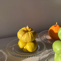 Heirloom Tomato Candle - Orange handmade artisan decor on elegant glass plates, showcasing handcrafted beauty.