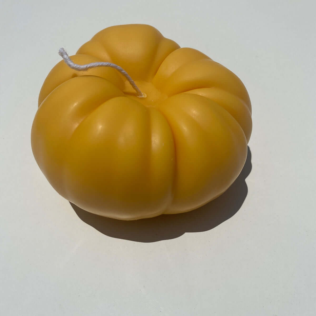Heirloom Tomato Candle - Orange, handcrafted artisan decor, natural soy wax candle shaped like a yellow heirloom tomato.