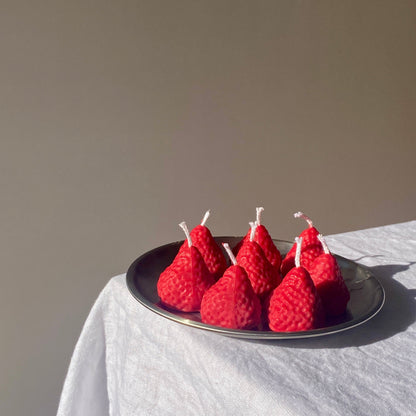 Strawberry Candles - 8 Pack arranged on a plate, showcasing their artisan handcrafted charm for home decor.