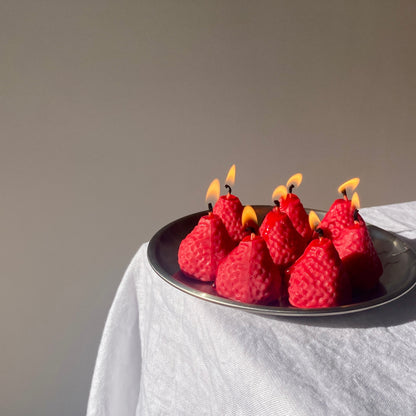Strawberry Candles - 8 Pack on a silver platter, showcasing artisan handmade decor with vibrant flames.