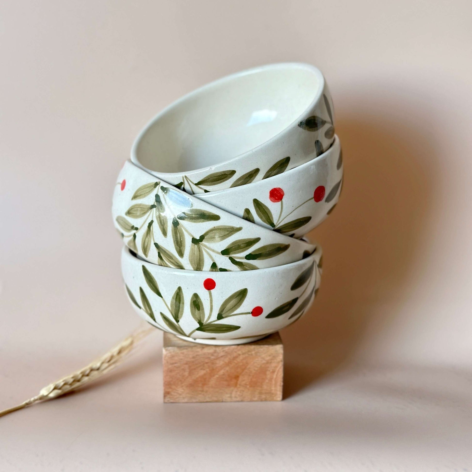 Holly Leaf Small Bowl Set in Olive | Ceramic Snack Bowls stacked on a wooden base with artisan design.