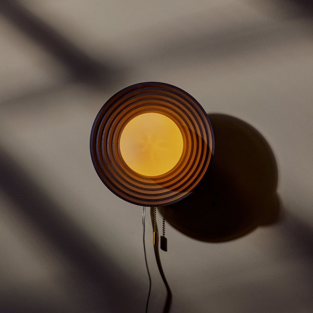 Echo Sconce featuring artisan concentric circle design, handcrafted decor adding uniqueness and charm to any space.