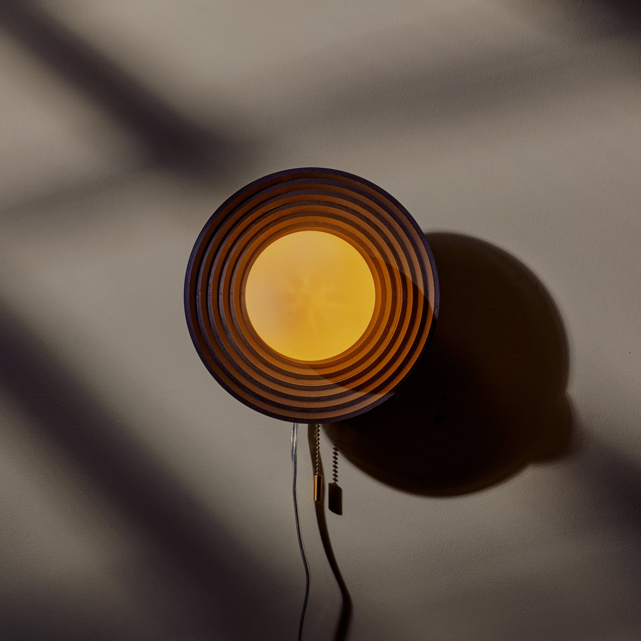 Echo Sconce featuring artisan concentric circle design, handcrafted decor adding uniqueness and charm to any space.