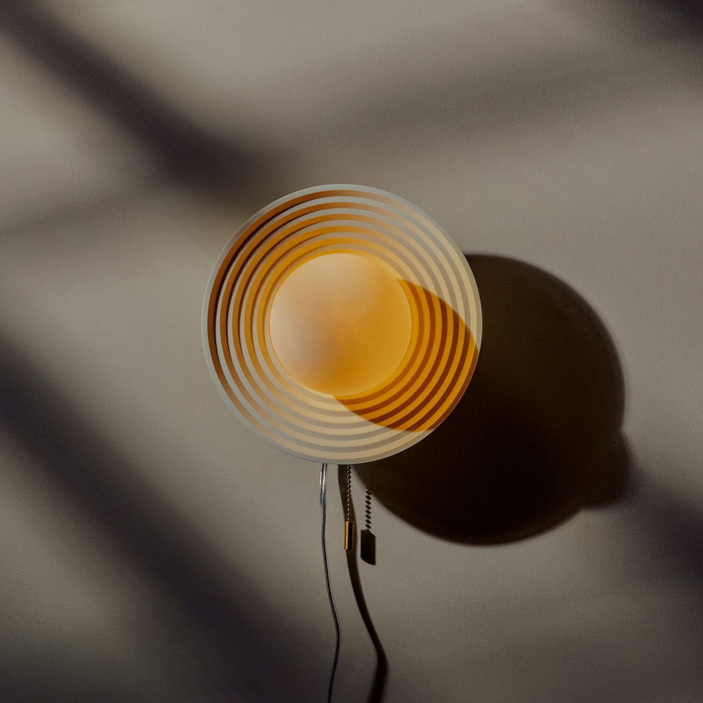 Echo Sconce showcasing artisan handmade concentric circle design, perfect for stylish decor.