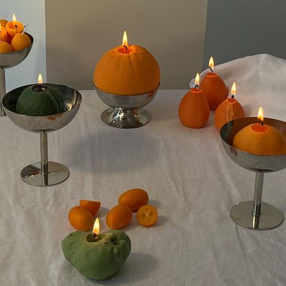 Artisan Cherimoya Candle display with unique handcrafted decor in vibrant colors on a white table.