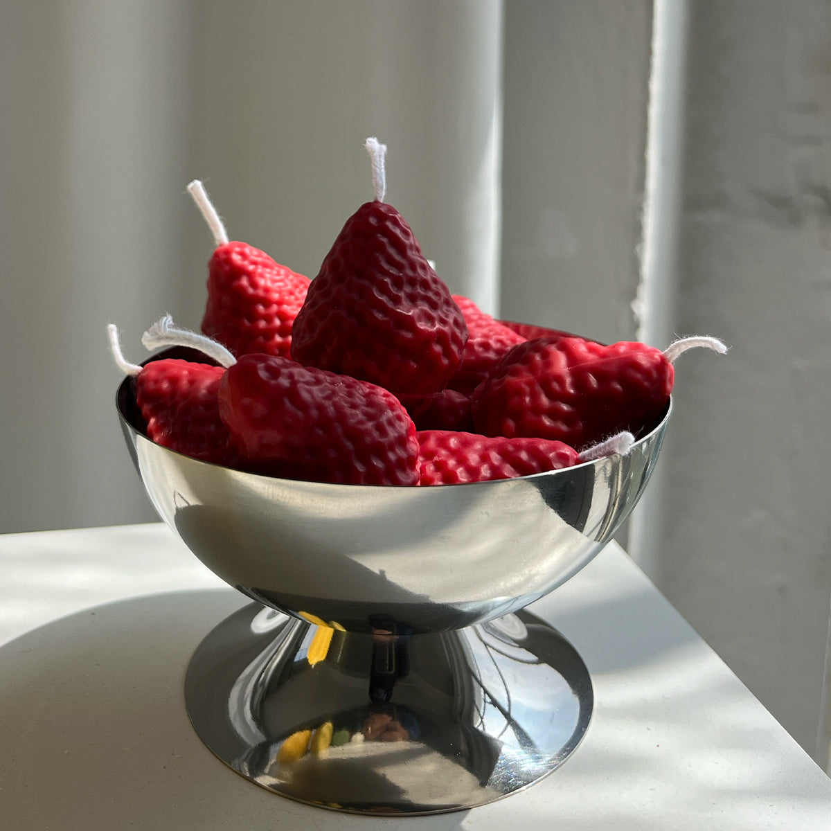 Strawberry Candles - 8 Pack in a shiny bowl, showcasing handcrafted artisan decor.
