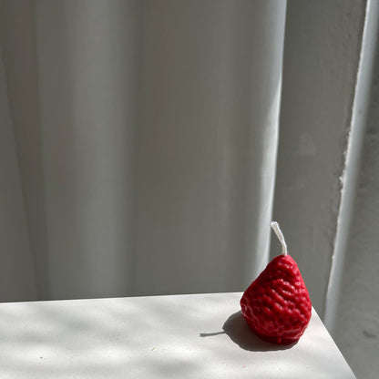 Strawberry Candles - 8 Pack, artisan handmade decor candle in the shape of a strawberry on a white surface.